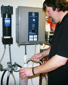 Photo of a WMU custodian filling a spray bottle at an aqueous ozone station.