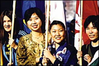 Photo of international students holding flags.
