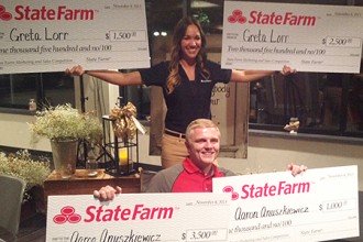 Photo of Greta Lorr and Aaron Anuszkiewicz with their scholarship checks.