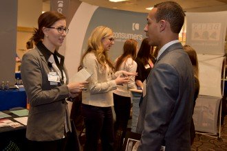 Photo of a male student interacting with a female Spectrum Health representative during the 2017 winter Career Fair.