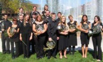Photo of the Western Horn Choir members in front of the Fine Arts plaza fountain. 