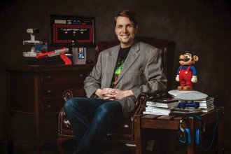 WMU's Dr. Whitney DeCamp sits in an office surrounded by video game paraphernalia.