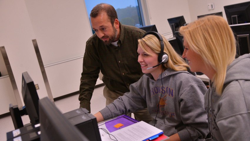 Professor Brian Horvitz working with two graduate students in computer lab