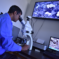 Dr. Joyashish Thakurta using a Petrological microscope.