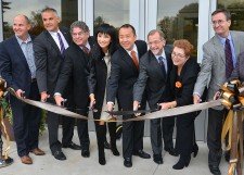 People cutting a ribbon in front of the Zhang Legacy Center