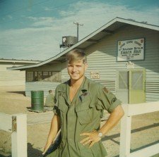 Photo of a young James McCloughan in fatigues in front of the Vietnam Regional Exchange Snack Shop.