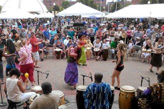 Photo of dancers and people playing African drums.