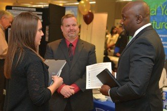 Photo of three people talking at a recent career fair.