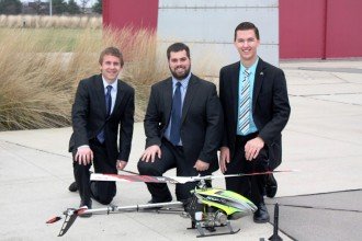Photo of engineering students with a small helicopter.