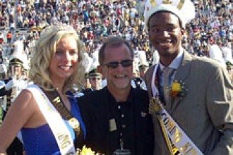 Photo of Homecoming Queen Katie Ballman and King Clifford Pulley III with President John Dunn.