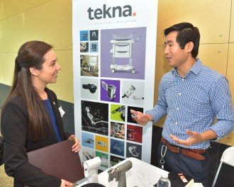 A student learns about Tekna from a company rep participating in the Engineering Expo.