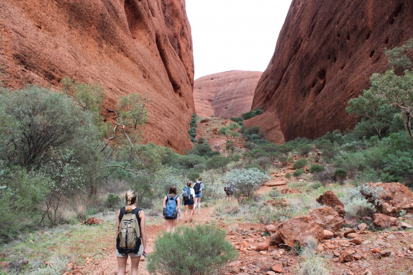 Hikers in Ayers Rock, Australia.