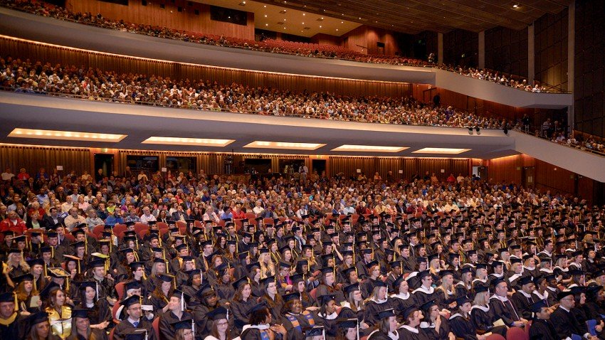 Photo of graduates seated in Miller Auditorium.