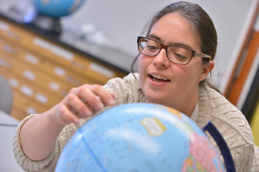 Student looking at globe